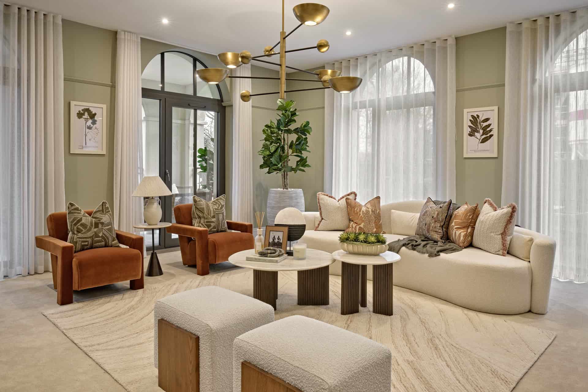 A living room with a large window and a large chandelier.
